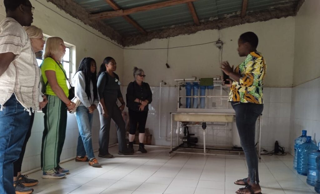 People learning about water-treatment equipment at the Centre of Love